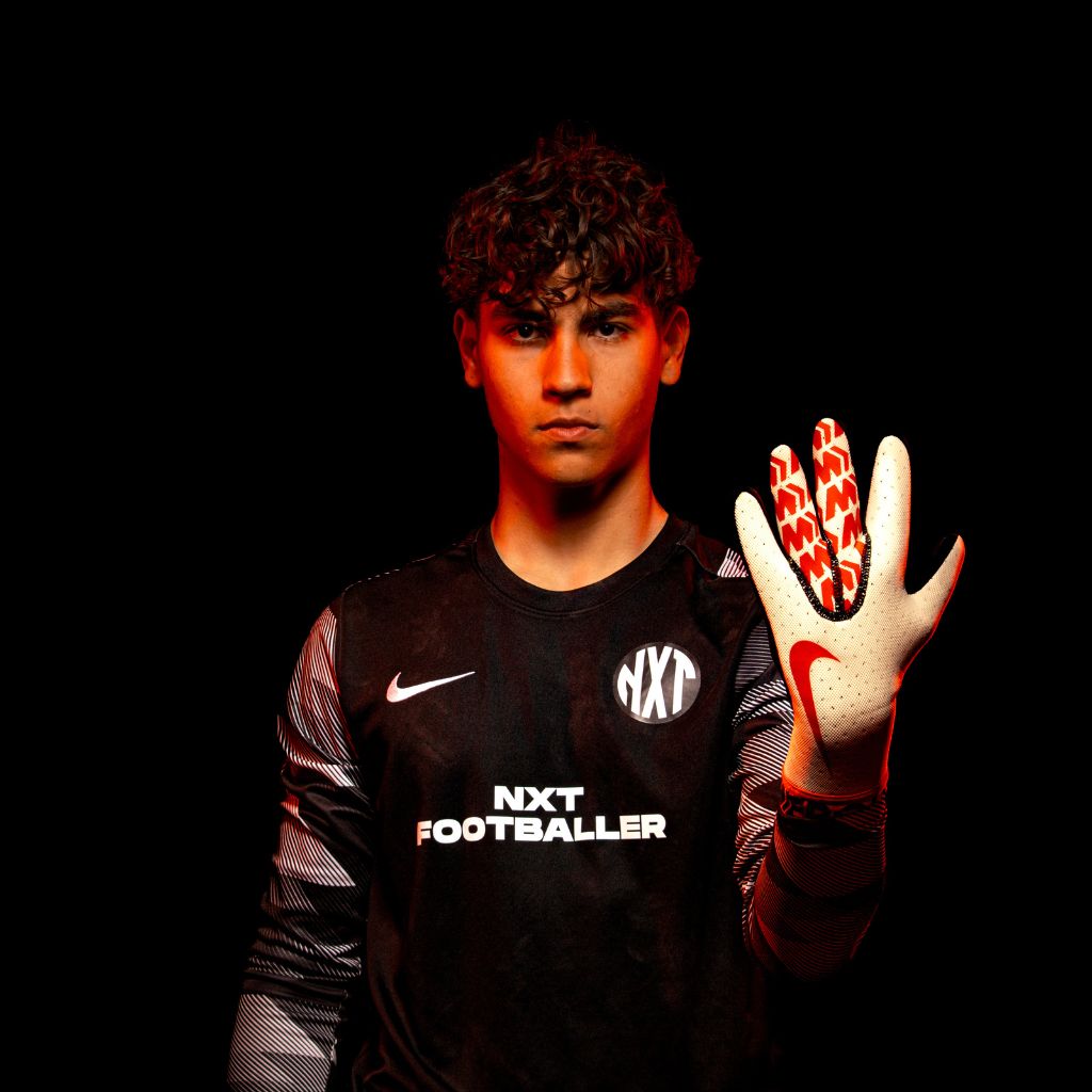 NXT football goalie holding up glove hand